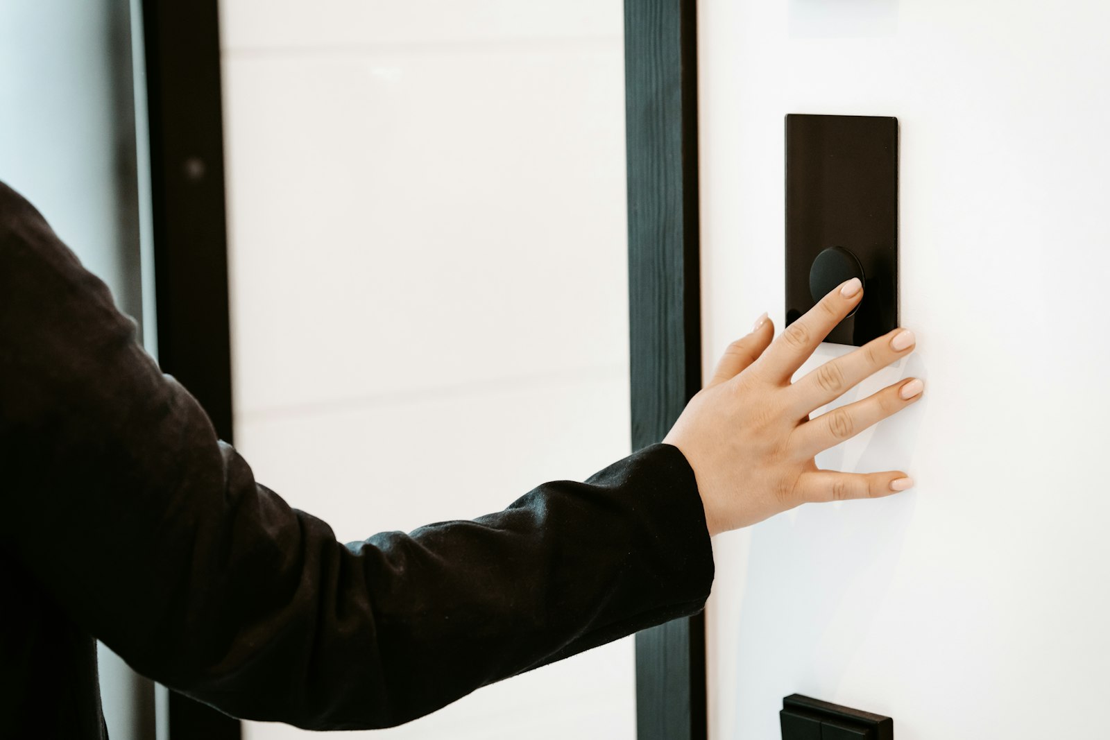 Resident using a wall-mounted building entry panel