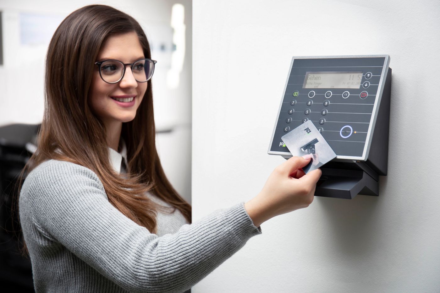 Employee using a card reader to open an office door